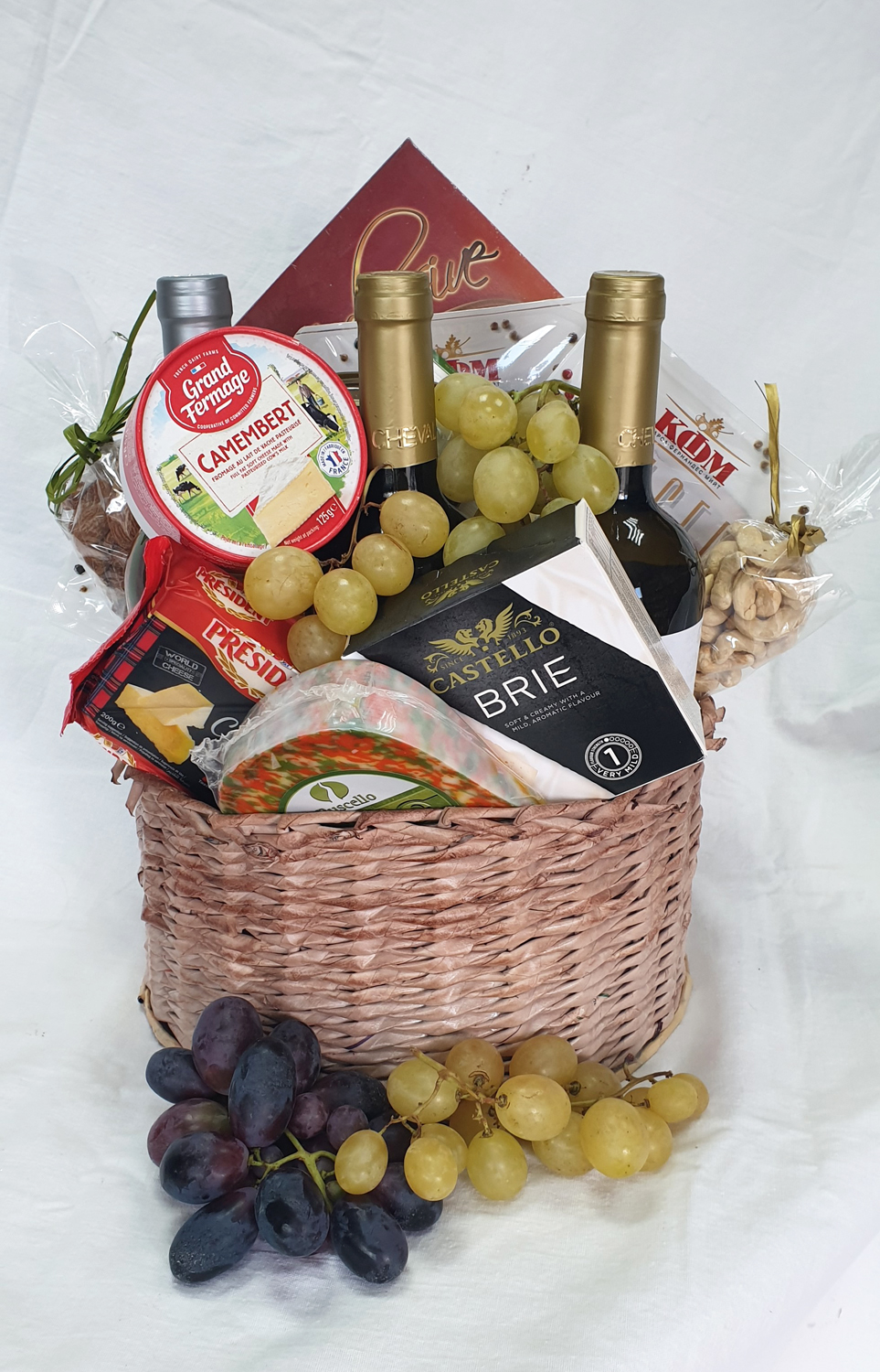 A luxury basket with selected cheeses and high-end wine