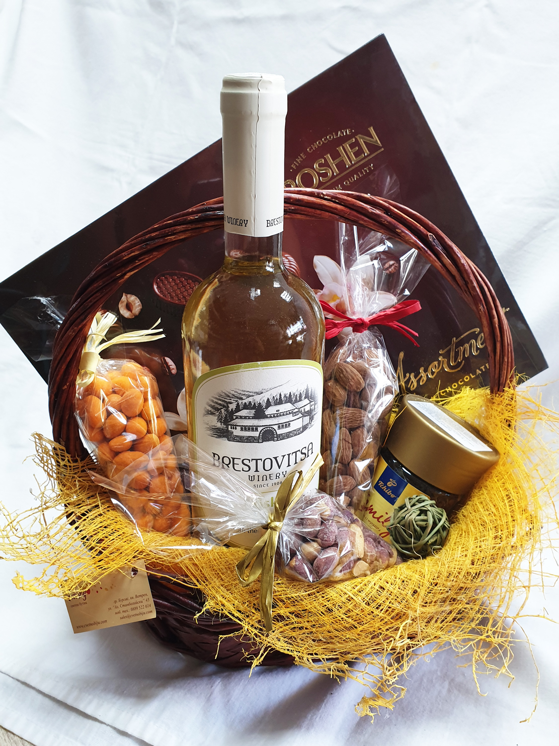 Basket with white wine and nuts with a yellow tinge